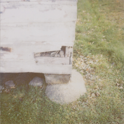 wood shed foundation : beam on boulder